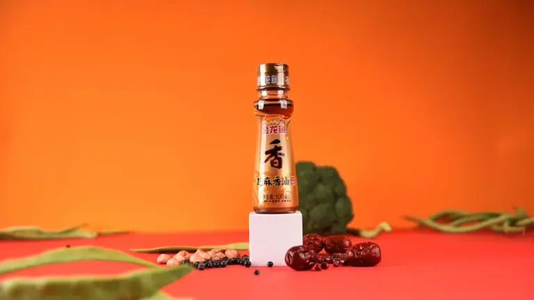 Small bottle of oil on a bright orange background with spices and greens, representing apricot, rosehip, truffle, grapeseed, and sesame seed oils for cooking and skincare.