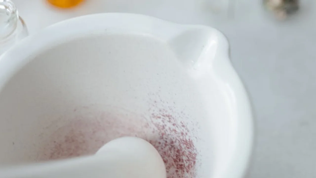White ceramic bowl with light traces of ingredients at the bottom, suggesting preparation for emulsions like mayonnaise.