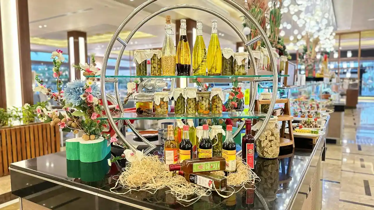 Display of carrier oil bottles on a retail counter with decorative plants and circular shelving