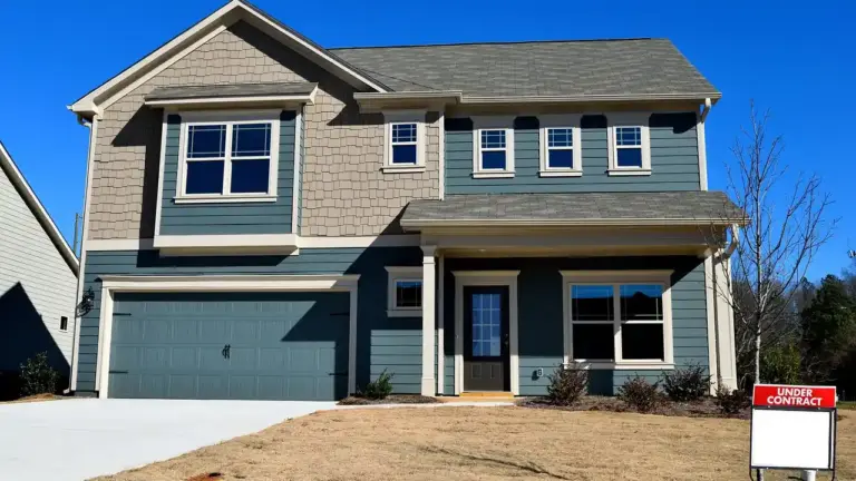 Two-story suburban home with a concrete driveway leading to a two-car garage