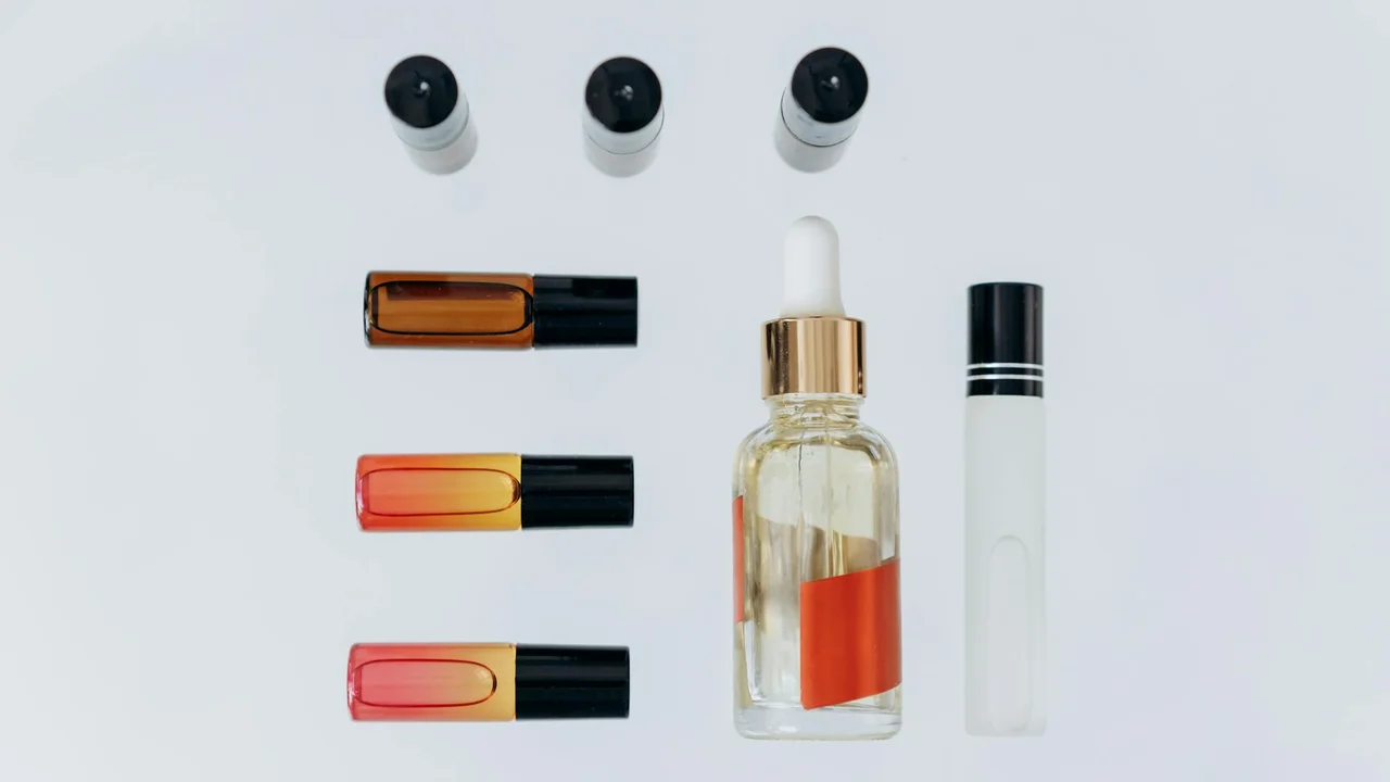 Assorted essential oil bottles with droppers and rollers on a light background