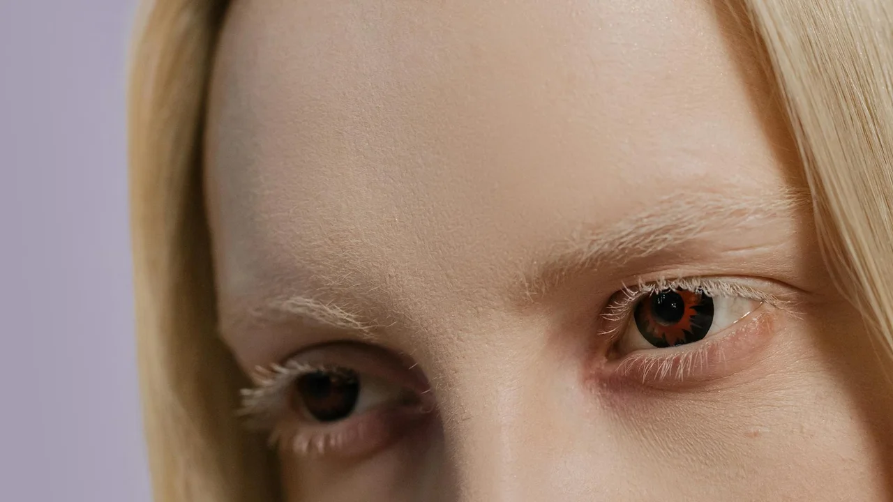 Close-up of a person's eyes with long eyelashes.