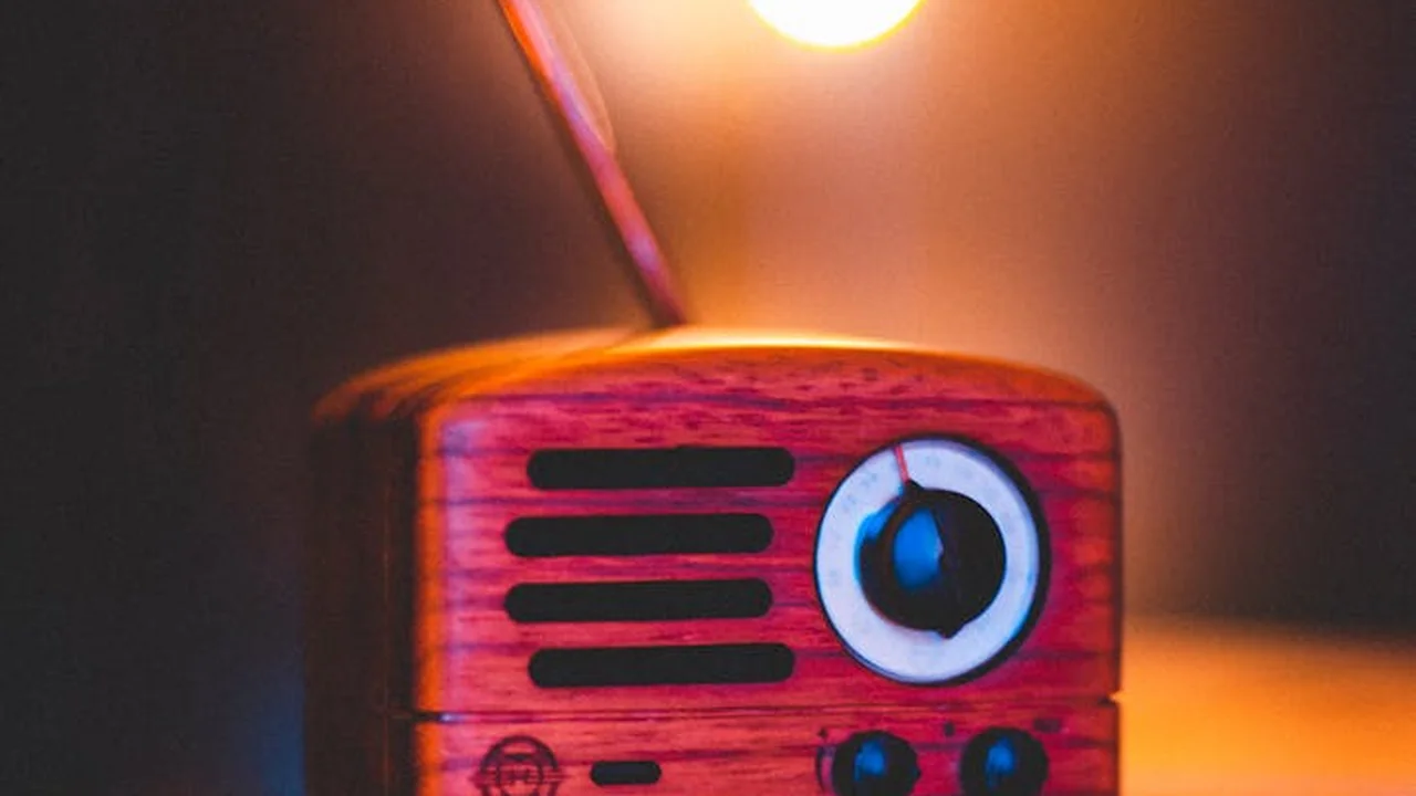 A small wooden radio toy bathed in warm light, symbolizing the careful, patient approach to applying wood finishing oils.