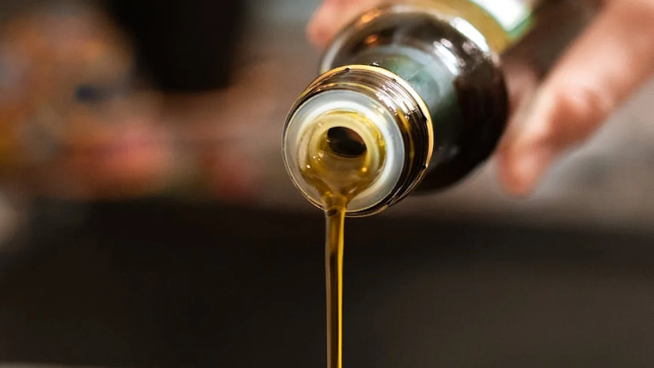 Close-up of vegetable oil being poured from a bottle