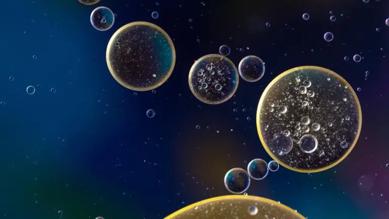 Abstract image showing oil droplets on a dark blue background, symbolizing oil stains