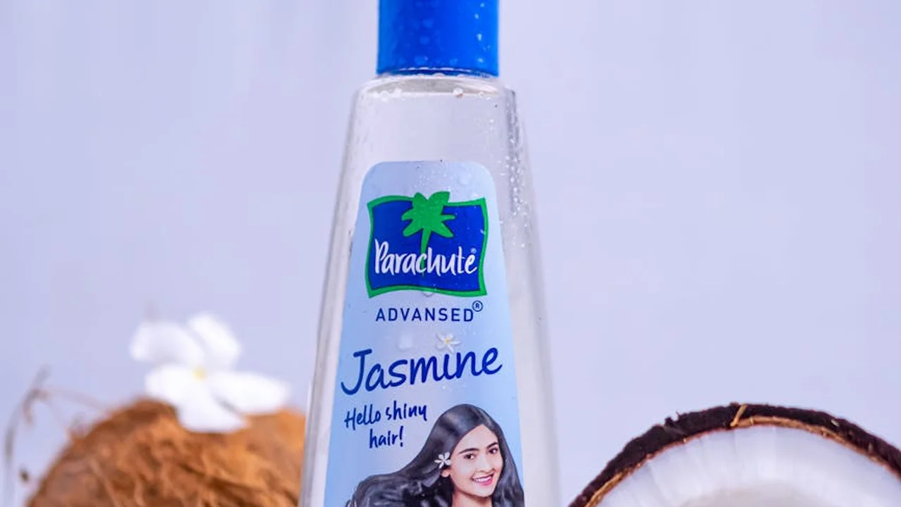 Bottle of Parachute Jasmine hair oil on a soft pastel background