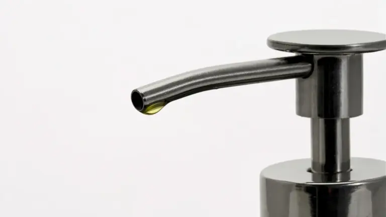 Close-up of a black pump bottle dispenser on a white background